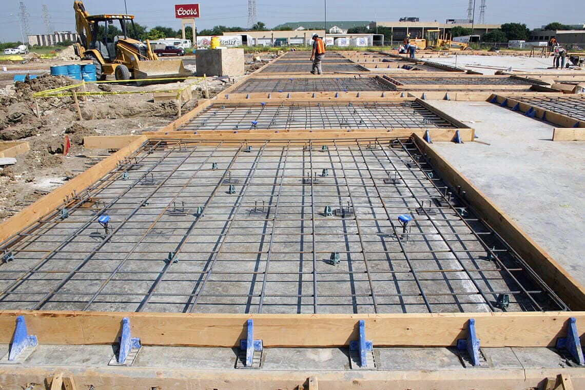 Tilt-up concrete wall panels being lifted into place on an SPM Services project